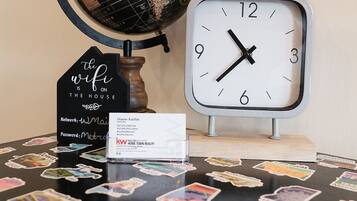 A globe, a clock, and a sign with a WiFi message on a table.