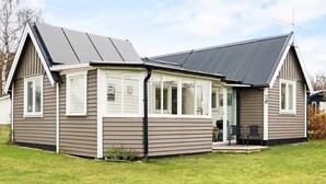 A single-story house with a gabled roof, a covered porch, and a small front yard. - 5 Person Holiday Home in Falkenberg (Falkenberg)