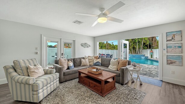 A living room with a sofa, coffee table, and a ceiling fan. - 2 Primary Suites | FREE Pool Heat | Great Beaches (Sarasota)