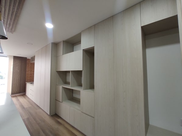 A modern interior with built-in shelving units and a wooden floor.