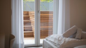 A bedroom with a large sliding glass door leading to a wooden deck. - VILLA DEI VENTI-BREVA by Curti rentals (Calozzo)