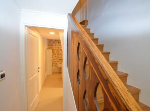 Stairs lead to a room with a door and a light fixture.