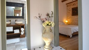 A room with a bed, a vase with flowers, a mirror, and a chandelier. - Serene Sea View Rovinj Apartment - Two Bedroom Apartment with Sea View (Rovinj)