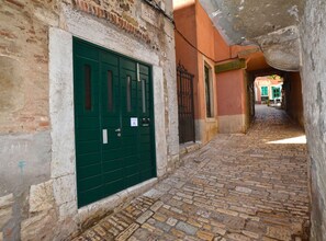 Discover a charming, historic entrance to a unique property, nestled in a traditional alleyway.