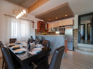 Enjoy meals in this stylish dining area with a dark table and comfortable leather chairs.