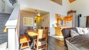 A modern interior with a dining area, a sofa, and a kitchen. - Neighborhood Beach Access! Soda Springs Getaway (Soda Springs)