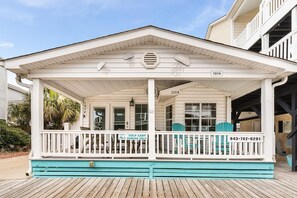 A beachfront building with a covered porch, numbered 1014, and a sign indicating golf cart parking. - Ocean Lakes Site 1014 3bed/2bath, Sleeps 8 Ocean View /Golf Cart (Myrtle Beach)