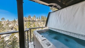 A hot tub on a balcony with a view of rocky terrain and trees. - Top of Kingsbury View Home 7BR,4BA,Spa, 5 To Ski (Stateline)