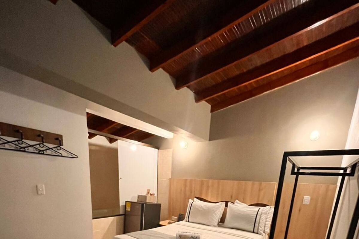 A hotel room with a bunk bed, a desk, and a chair.