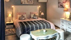 A bedroom with a bed, bedside tables, a nightstand, a lamp, a dresser, and a small table with a decorative item. - Pet friendly home in CAVAILLON (CAVAILLON)