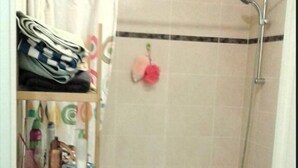 A small bathroom with a shower, a sink, and a shelf with folded towels and toiletries. - 850 metres from Disney Land and Valley Village - 3 bedrooms - Sleeps 8 (Serris)