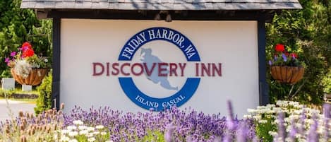 A sign for Discovery Inn in Friday Harbor, WA, featuring a logo with a silhouette of a person and the words "Island Casual."