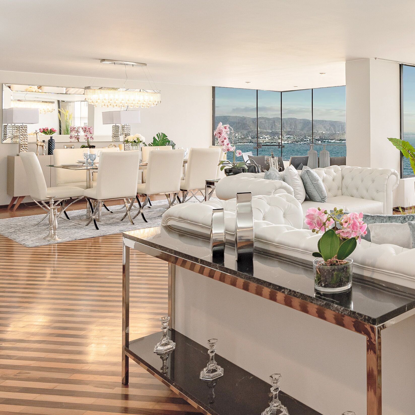 A modern living room with a large window, a dining area, and a view of the city.