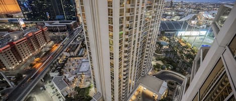 A high-rise building with multiple floors, surrounded by other buildings and a busy street.