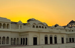 A historic building with multiple domes and arches, featuring intricate architectural details.