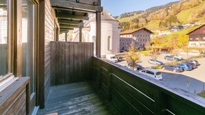 A balcony with a view of a parking lot and buildings in the background. - Apartment near ski lift and ski bus in Brixen (Brixen)