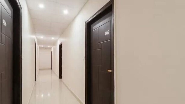 A corridor with doors numbered 405, leading to rooms. - Rabbit Hut Guest House By GRB (Dehradun)