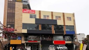 A multi-story building with a sign for "UK07 TOWER" and "GUEST HOUSE". - Rabbit Hut Guest House By GRB (Dehradun)
