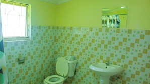 A bathroom with a toilet, sink, and a window. - mirok gardens kisumu (Kisumu)