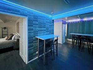 Contemporary room with a glass partition wall, dining table, and comfortable seating area.