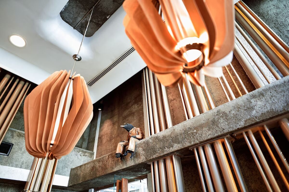 A modern interior with exposed ductwork and a concrete ceiling.