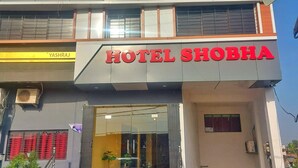 A multi-story building with a prominent sign reading "HOTEL SHOBHA" at the ground level. - Hotel Shobha (Forbesganj)