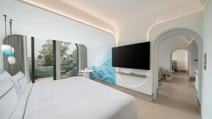 A modern hotel room with a large bed, a flat-screen TV mounted on the wall, and a balcony with a view of the city.