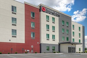 A modern hotel building with a prominent 'Candlewood Suites' sign, multiple windows, and a parking lot. - Candlewood Suites Morristown West by IHG (Morristown)