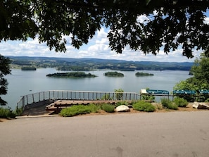 A lakeside viewpoint with a wooden deck, a metal railing, and informational signs. - Candlewood Suites Morristown West by IHG (Morristown)
