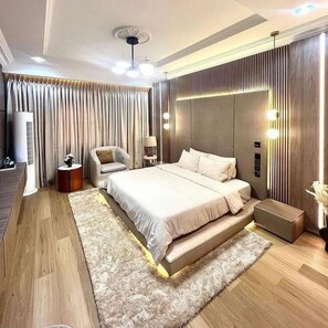 Relax in comfort with a large bed, bedside table, and plush rug.