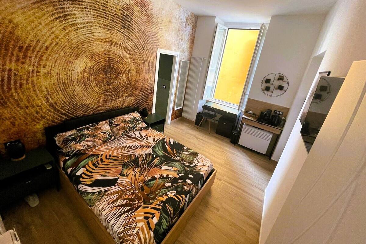 Une chambre à coucher avec un lit, un bureau et une fenêtre.