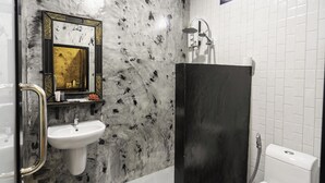 A bathroom with a marble sink, a black shower enclosure, and a white tiled wall. - El Matcha Lanta Resort (Ko Lanta)