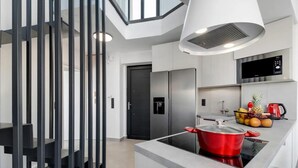 A modern kitchen with a built-in stove, stainless steel appliances, and a fruit bowl on the counter. - Villa Andria With 5 Bedrooms and 5 Bathrooms (Lefkada)