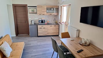 Superior Apartment, Garden View | Living area | TV