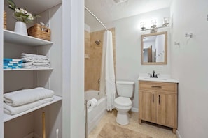 Shower, hair dryer, towels, shampoo