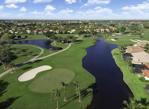A golf course with water hazards, sand bunkers, and a pond. - Restoration Hardware PGA National Gated Community by Guaranteed Rental™ (Palm Beach Gardens)