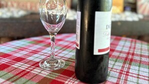A wine bottle and a glass on a checkered tablecloth. - Authentic Mikoko Beach & Cottages (Bagamoyo)