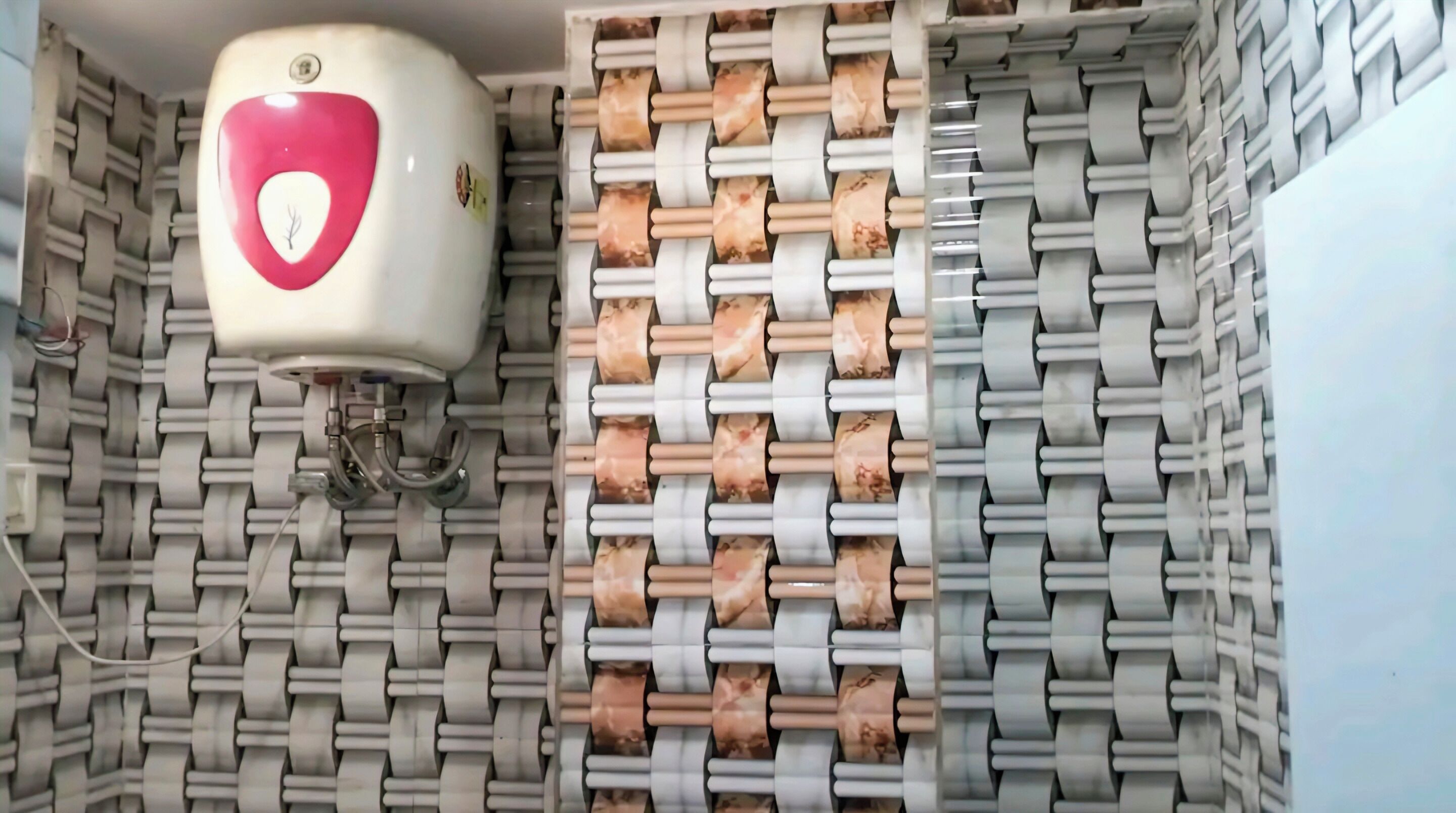 A wall with a patterned design and a hand sanitizer dispenser mounted on it.