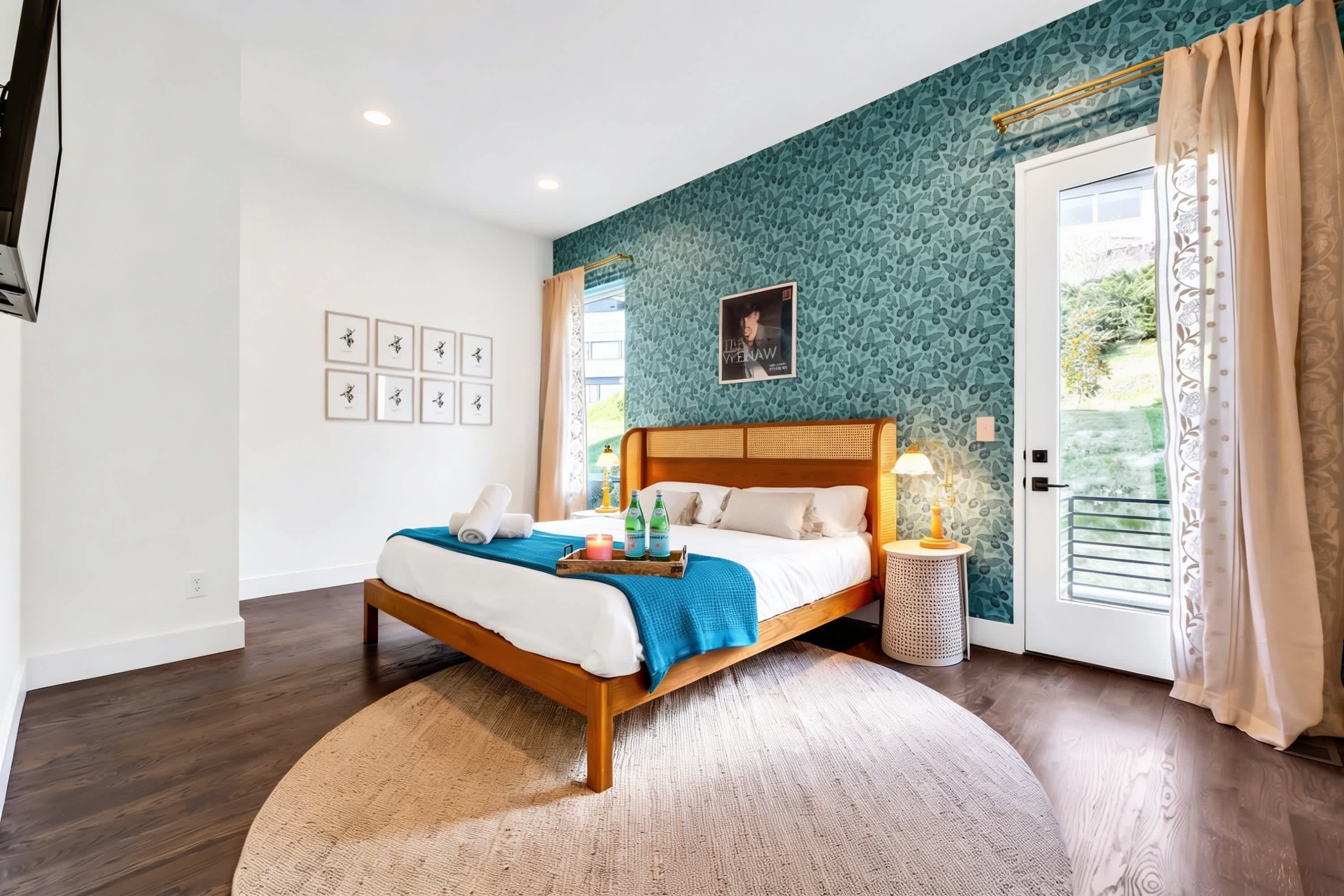 A bedroom with a bed, bedside table, and a window with curtains.