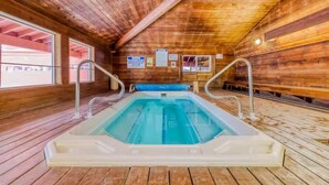 A wooden cabin with a hot tub in the center, wooden walls, and a window on the left. - Giant Steps #5 Ski / Ski out (Brian Head)