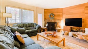 A cozy living room with a fireplace, a television, and comfortable seating. - Giant Steps #5 Ski / Ski out (Brian Head)