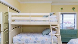 A bunk bed with a lower bunk, a ladder, and a window with blinds. - Sunset Point - 63rd st, 3 BR, Pool (Ocean City)