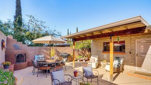 An outdoor patio with a barbecue area, seating, and a pergola. - Cyclists' Haven: Southwestern-style Home in Tucson (Tucson)