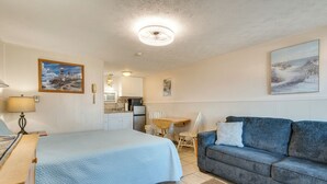 A bedroom with a bed, a sofa, a desk, and a chair. - 'beachfront 15' Condo on Old Orchard Beach (Old Orchard Beach)