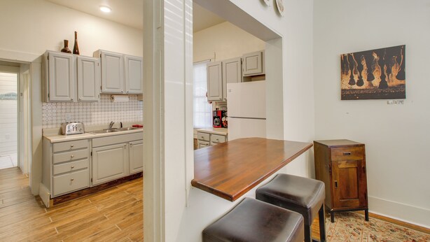 A kitchen with wooden cabinets, a wooden countertop, and a small wooden cabinet. - Near Oaklawn Casino & Dtwn: 'capone's Hideout' (Hot Springs)
