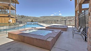 A hotel patio with a hot tub, pool, and outdoor seating area. - 2 Mi to Granby Ranch: Studio w/ Resort Amenities! (Granby)