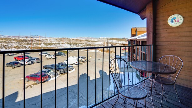 A balcony with a view of a parking lot and distant landscape. - 2 Mi to Granby Ranch: Studio w/ Resort Amenities! (Granby)