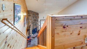 A wooden staircase leading to a stone fireplace, with a skylight above and a framed picture on the wall. - 2 Mi to Granby Ranch: Studio w/ Resort Amenities! (Granby)