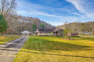 A residential house with a front yard, driveway, and garage.