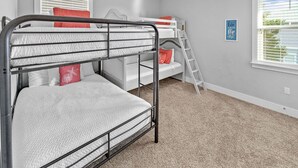 A bunk bed room with a ladder, a desk, and a window with blinds. - Golf Cart & 4 Bikes! Steps to Pool! Bike to Beach! King Master & 2 Sets of Bunks! ~ Coconut Cottage in Highland Parks on 30A (Santa Rosa Beach)